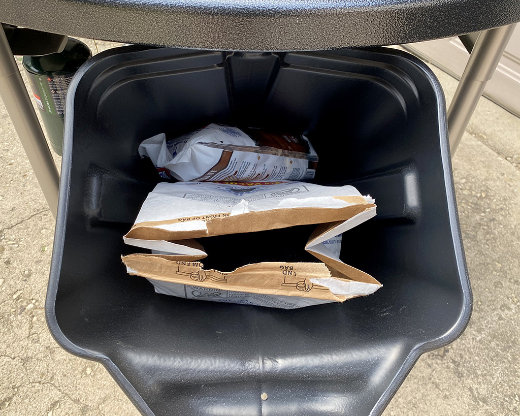 Weber Perfomer Deluxe CharBin inside view with charcoal bag inside