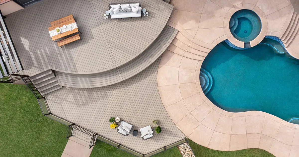 A two tier grey trex deck and inground pool